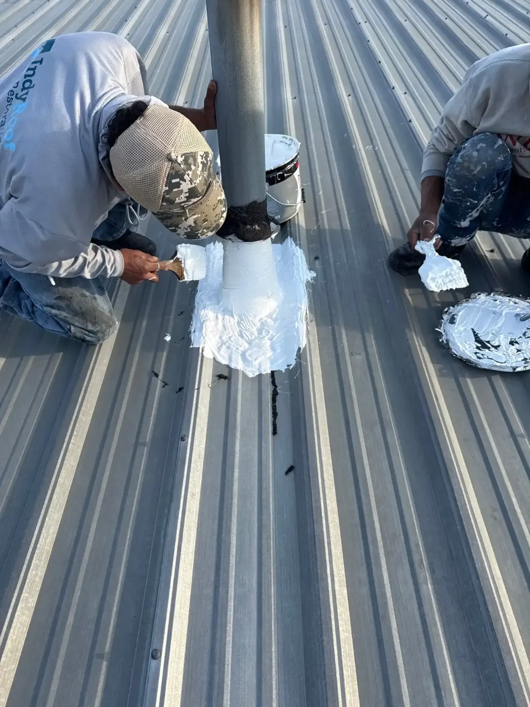 Tarping and dry-in on a Woodcreek Crossing commercial roof